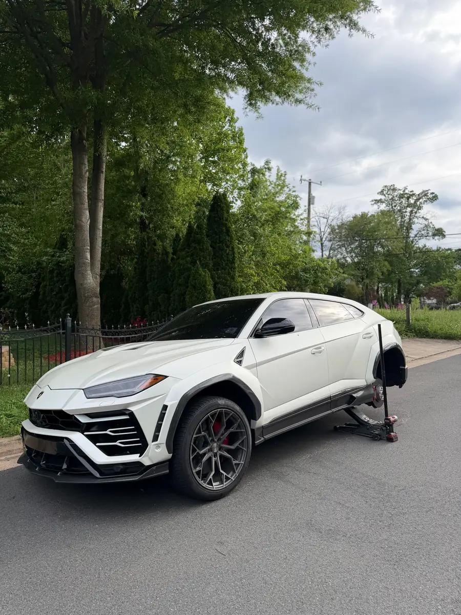 TRS mobile tire service working on a white Lamborghini Urus