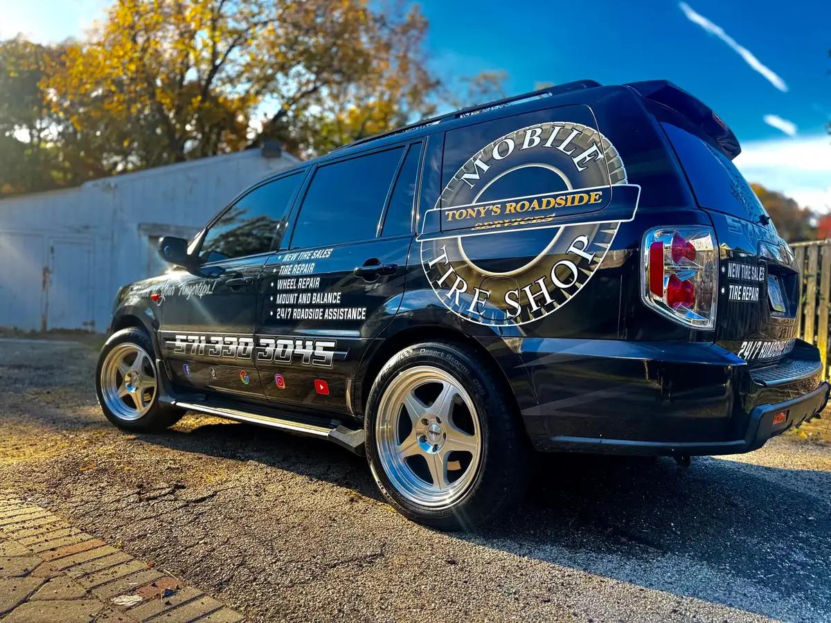 The original black TRS wrapped Pilot parked outside