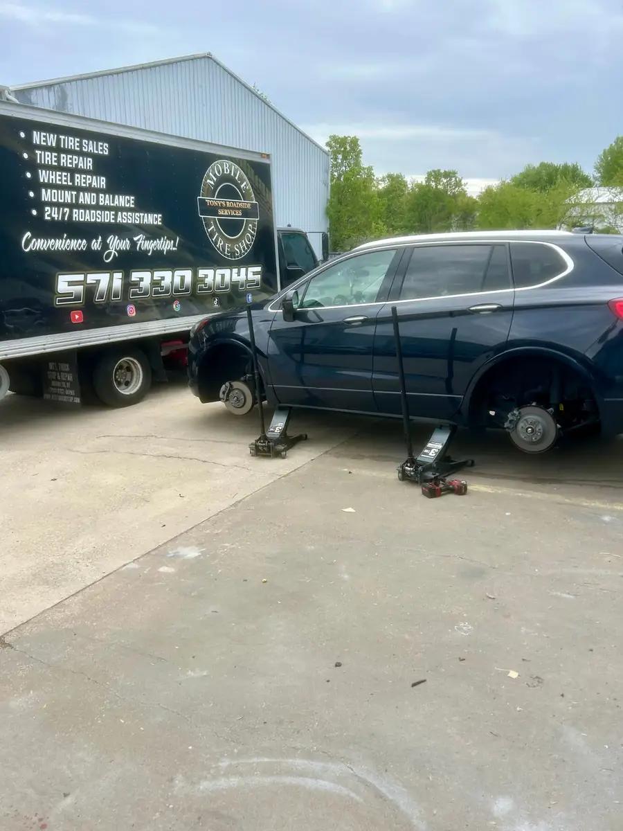 TRS mobile tire installation with an SUV lifted beside the service truck