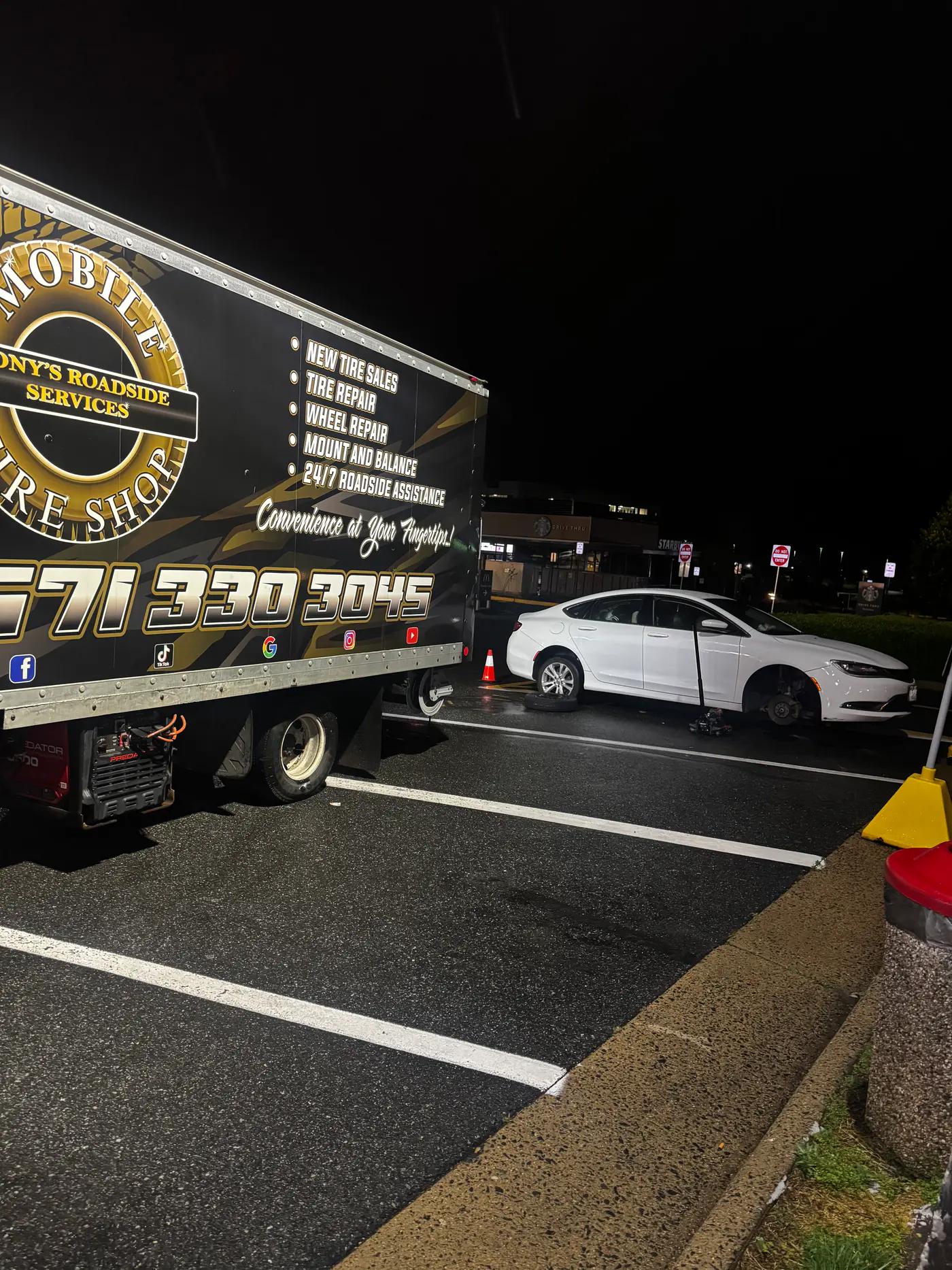 TRS mobile tire service assisting a white sedan at night