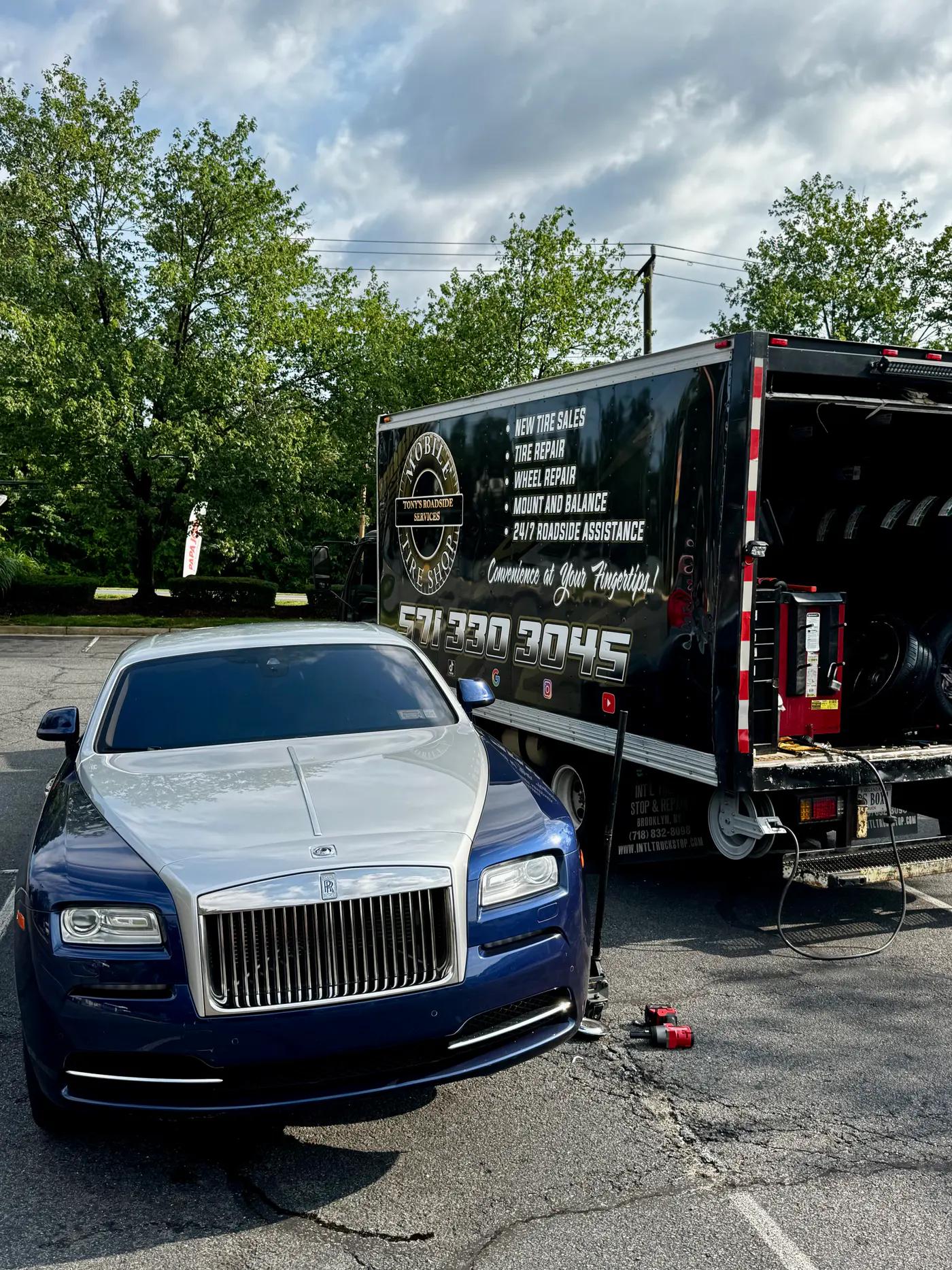 TRS mobile tire service truck working beside a blue Rolls-Royce