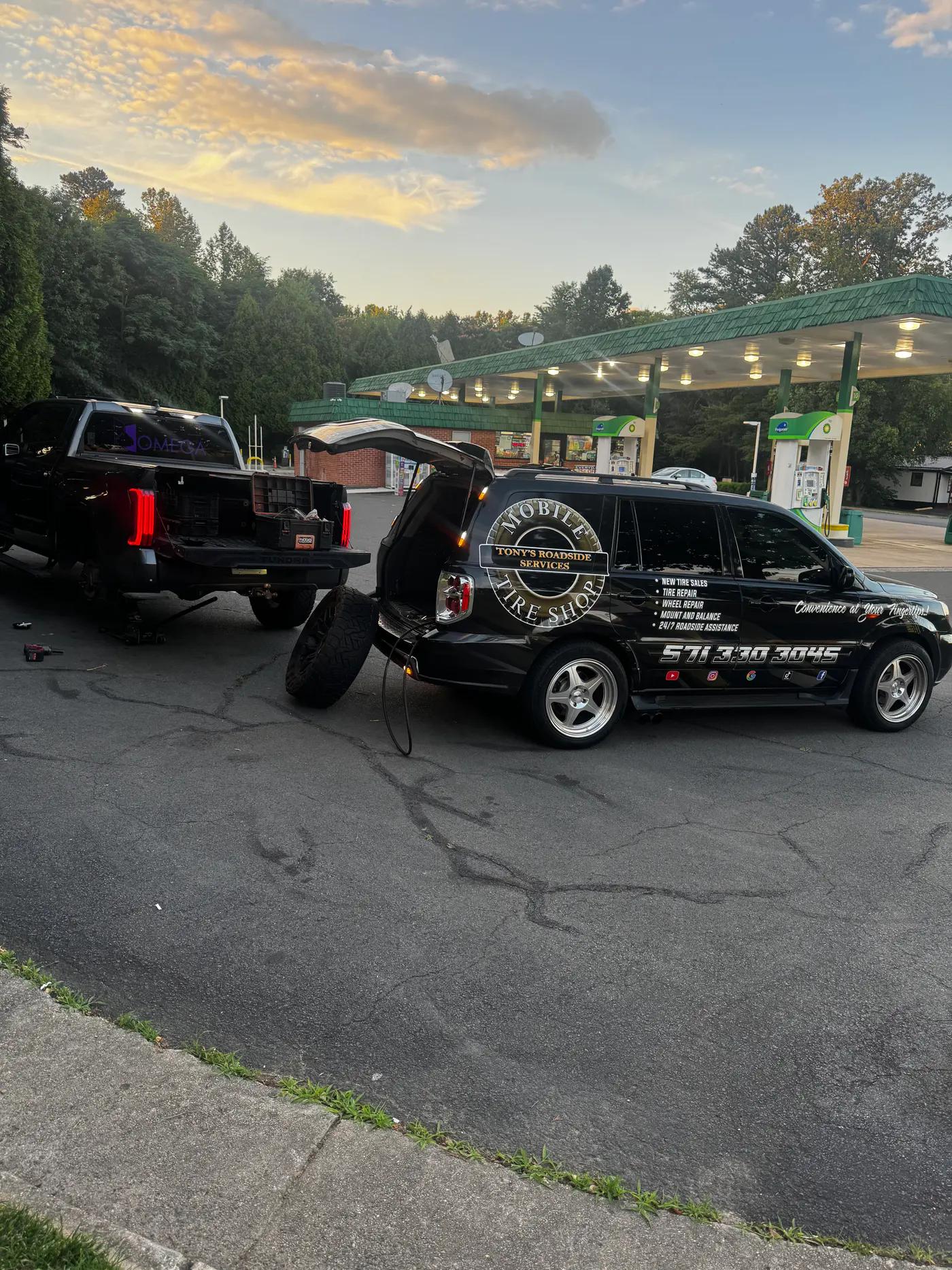 Two TRS mobile tire service vehicles assisting a customer near a gas station