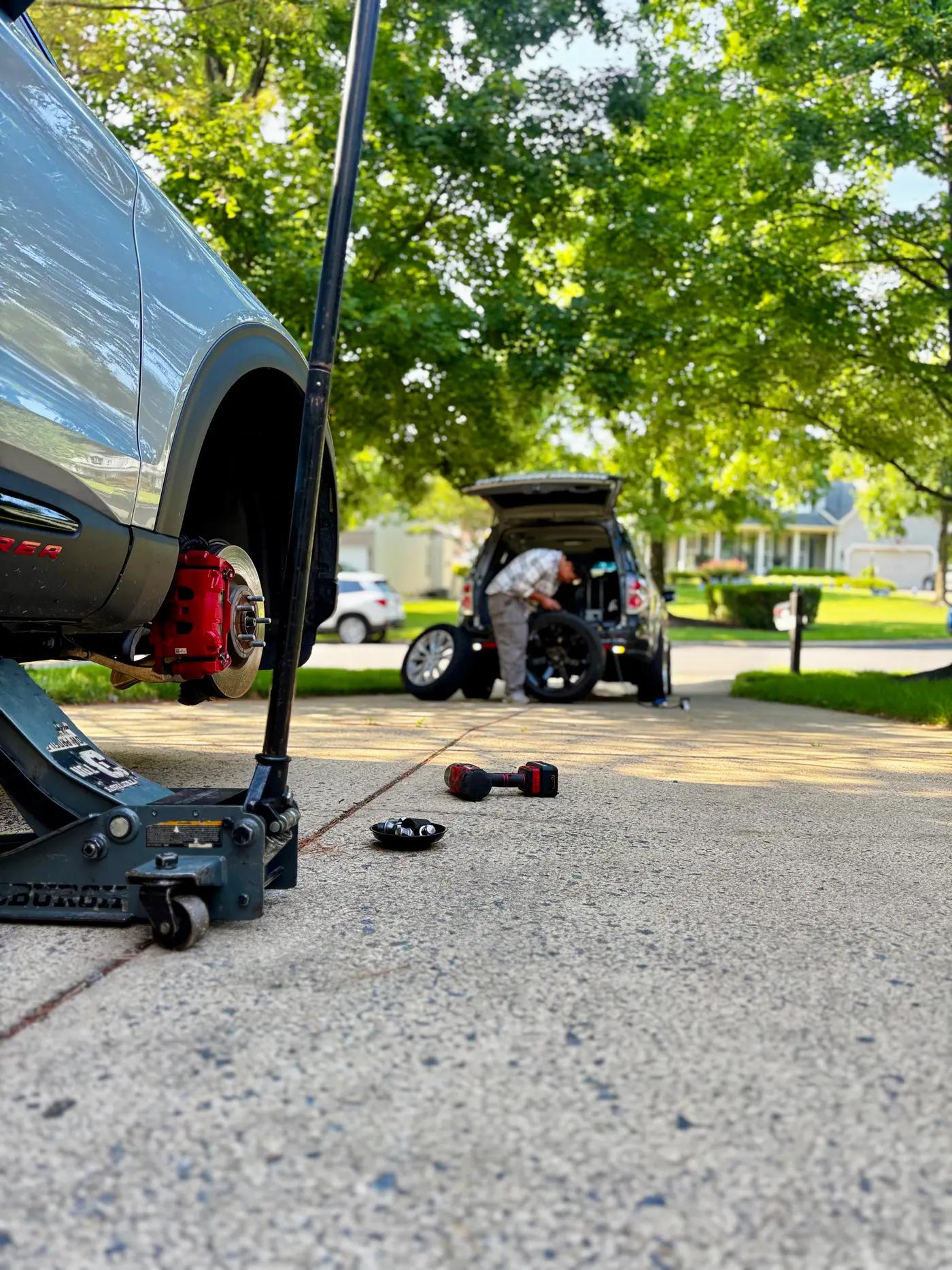 TRS technician preparing a performance vehicle wheel for mobile tire service